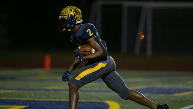 Jonas Duclona of Naples High School returns an interception for a touchdown.